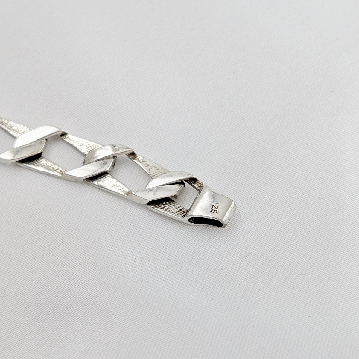 A Modernist Sterling Silver Faceted Curb Link Bracelet