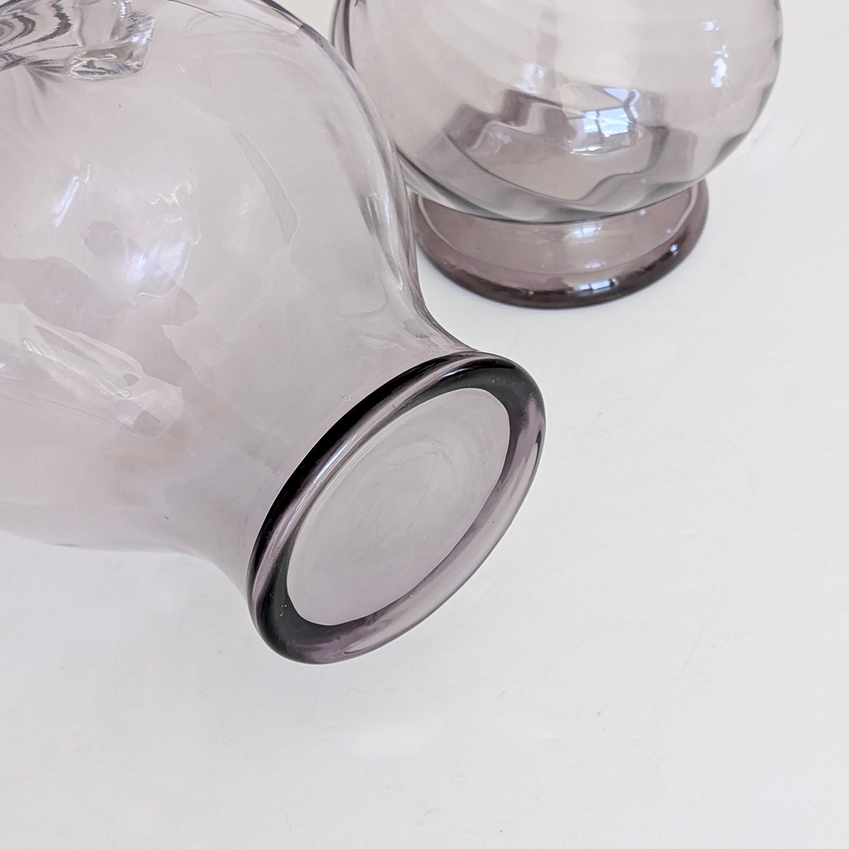 Two Large Purple Glass Pitchers
