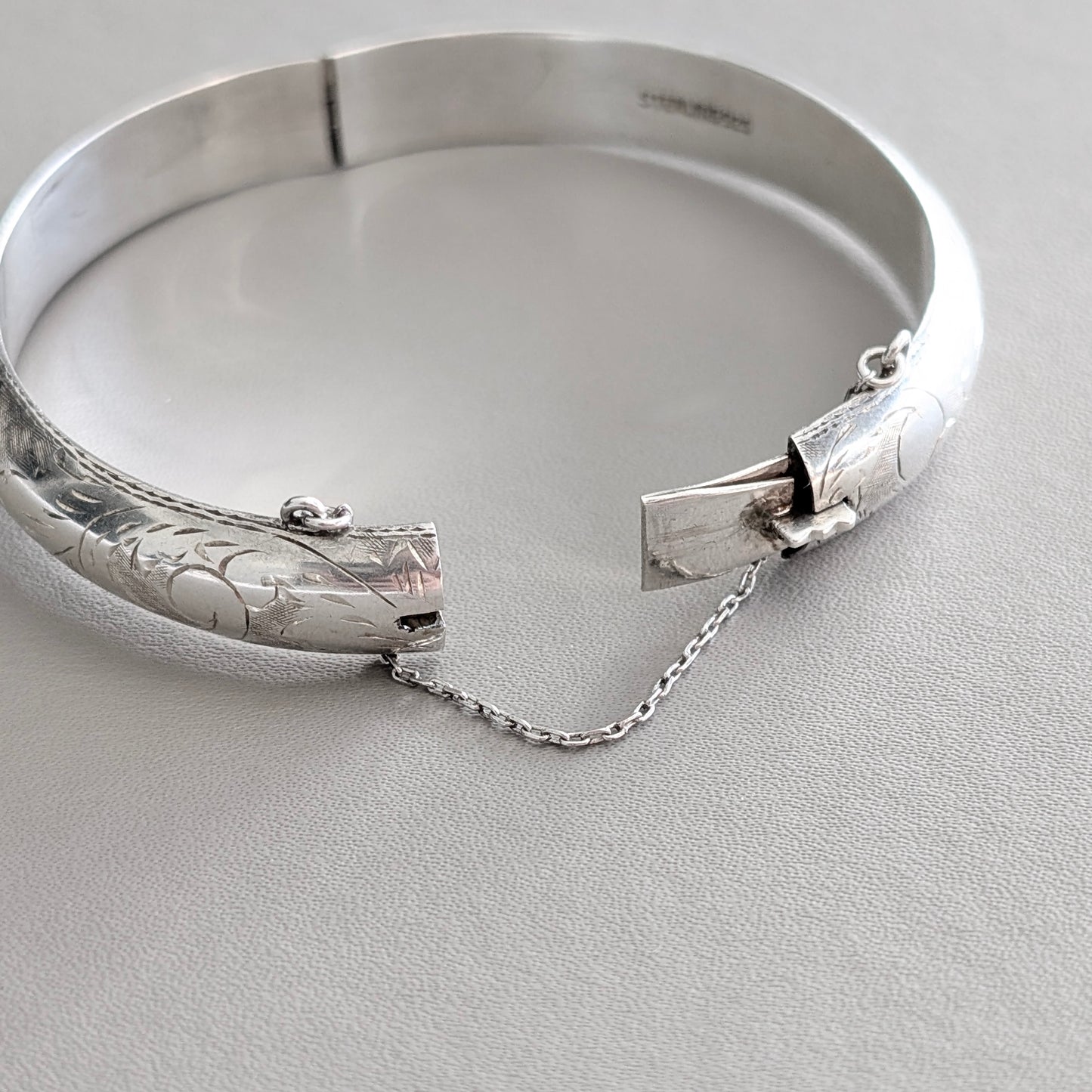A Hinged Sterling Silver Bangle with Engraved Design