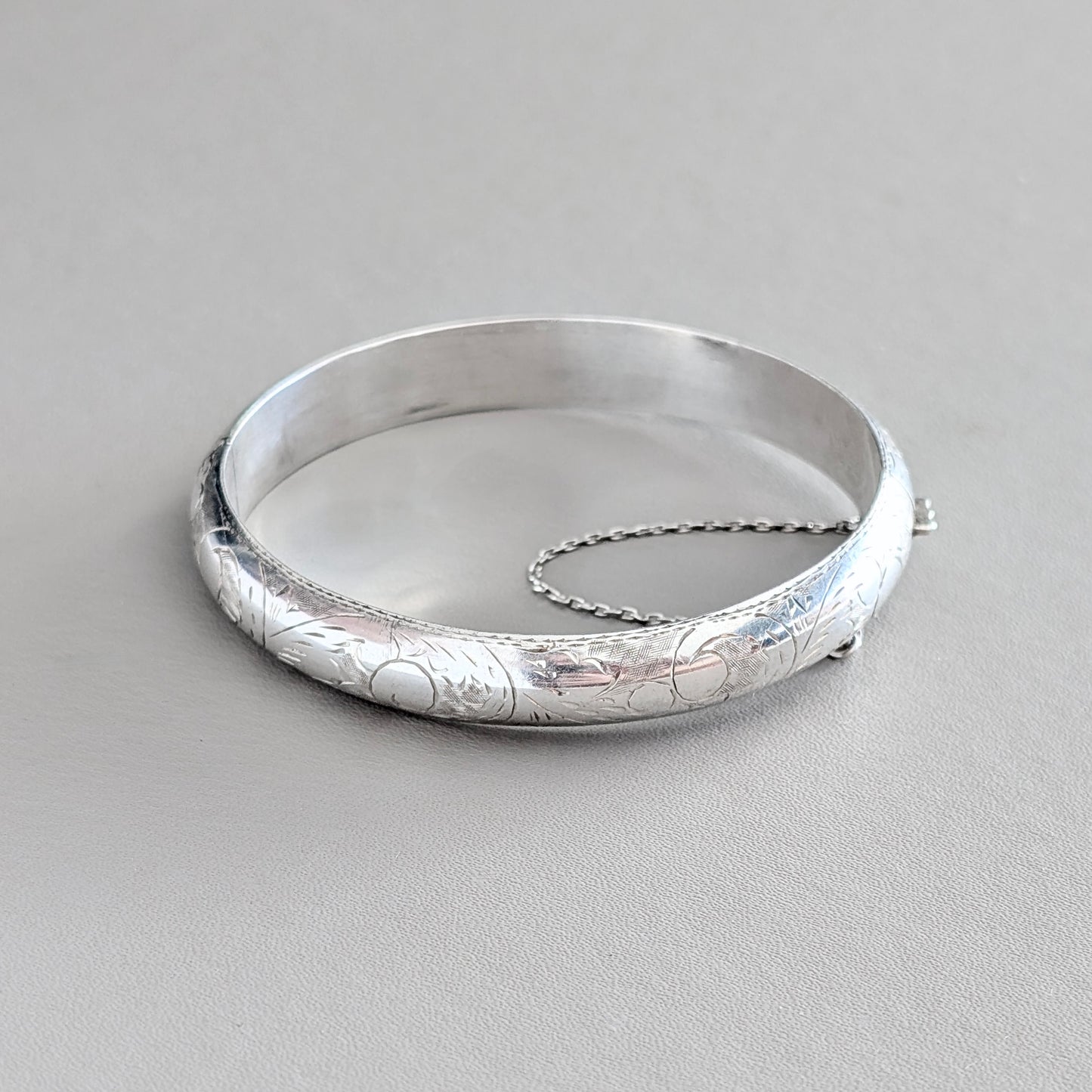 A Hinged Sterling Silver Bangle with Engraved Design