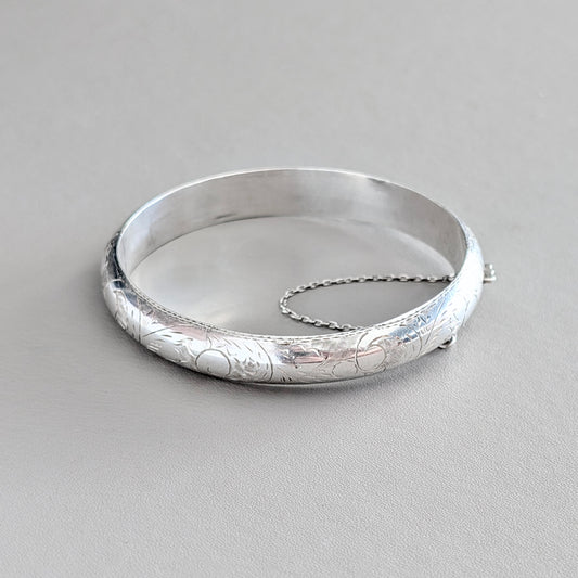 A Hinged Sterling Silver Bangle with Engraved Design