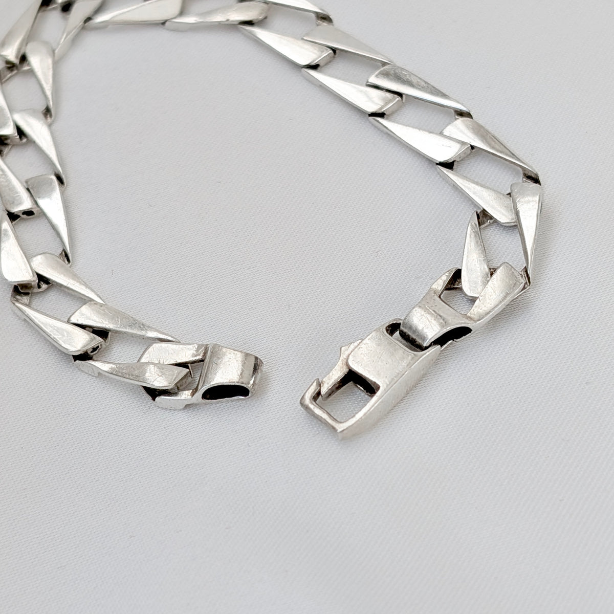 A Modernist Sterling Silver Faceted Curb Link Bracelet