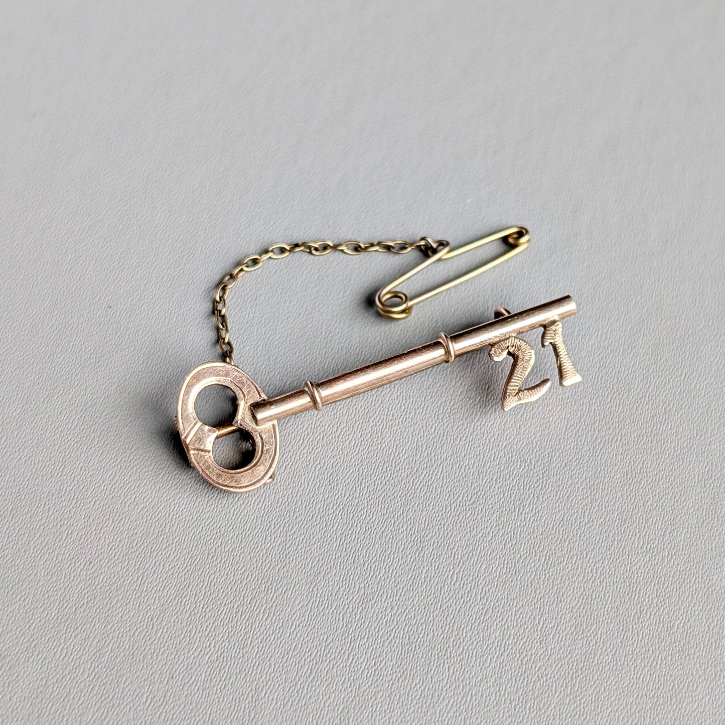 An Australian 9ct Rose Gold "21" Key Brooch, c1900