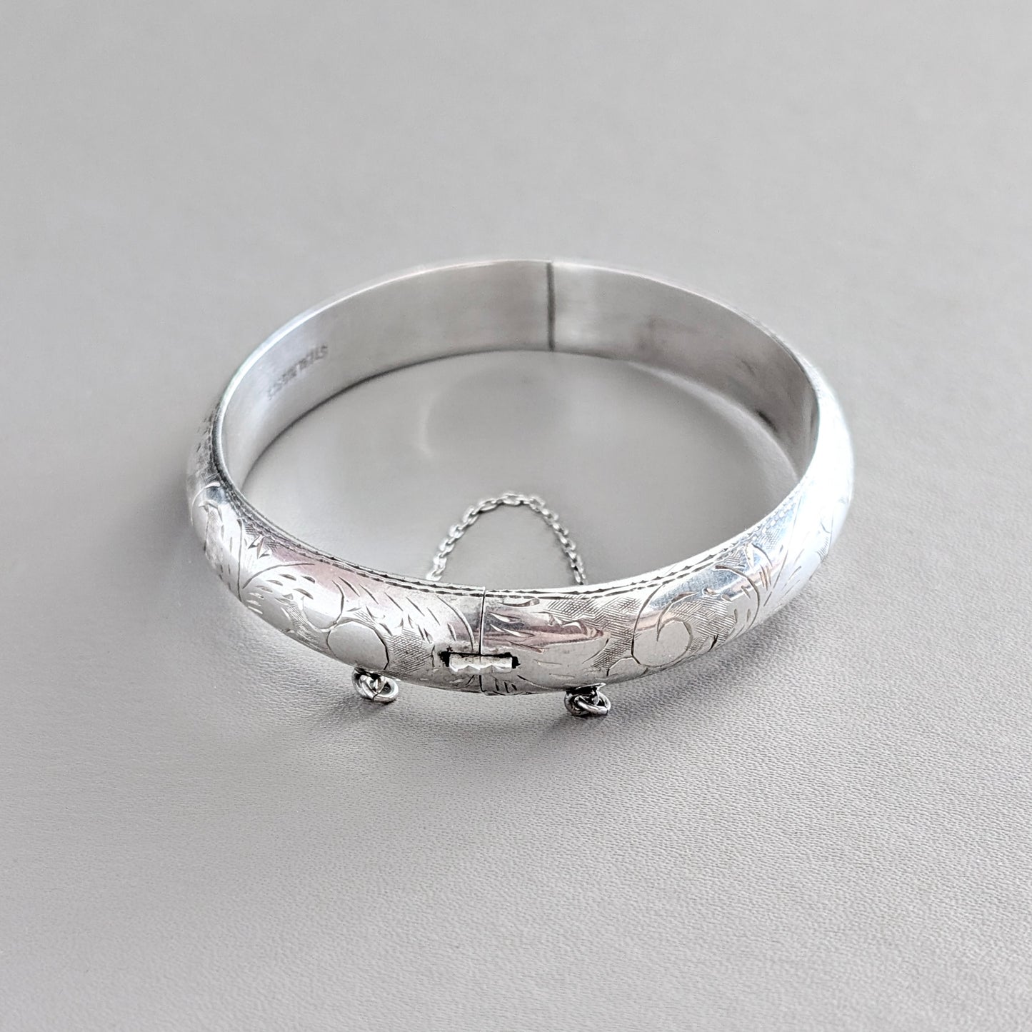 A Hinged Sterling Silver Bangle with Engraved Design