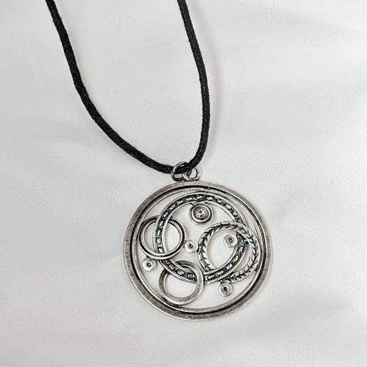 A Large .835 Silver Pendant on a Woven Cord Necklace