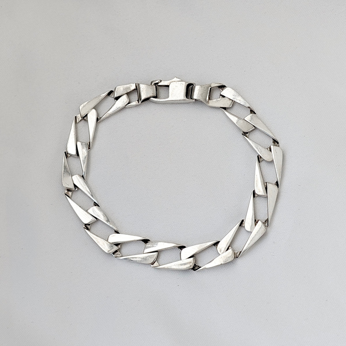A Modernist Sterling Silver Faceted Curb Link Bracelet