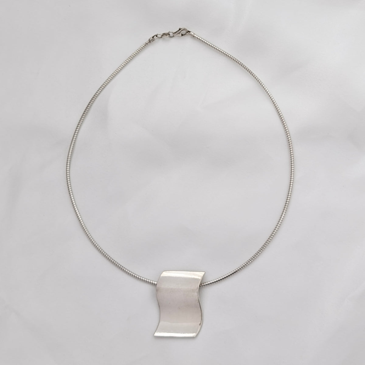 A Modernist Sterling Silver Pendant on Omega Chain
