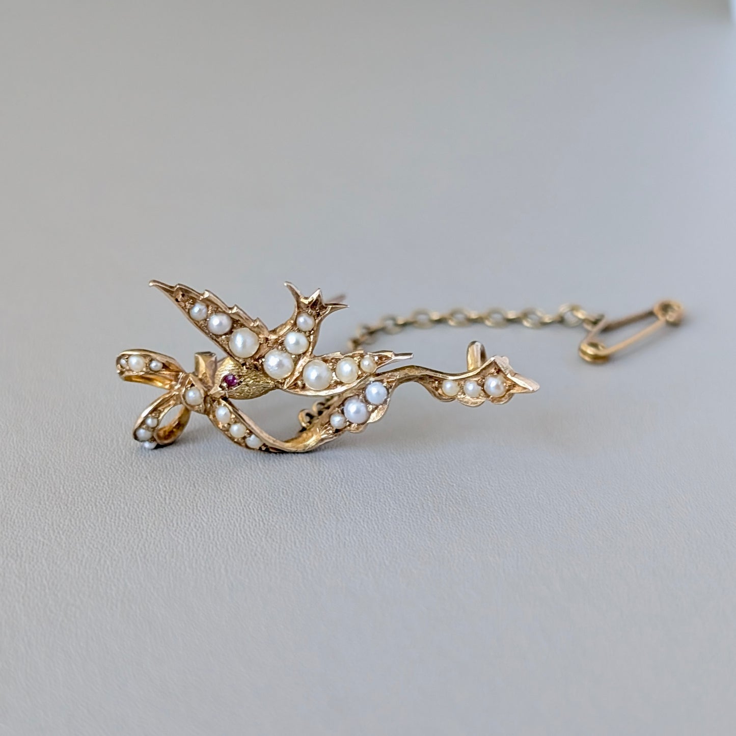 An Australian 15ct Gold Seed Pearl & Ruby Bird Brooch, c1900