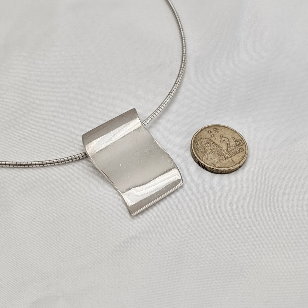 A Modernist Sterling Silver Pendant on Omega Chain