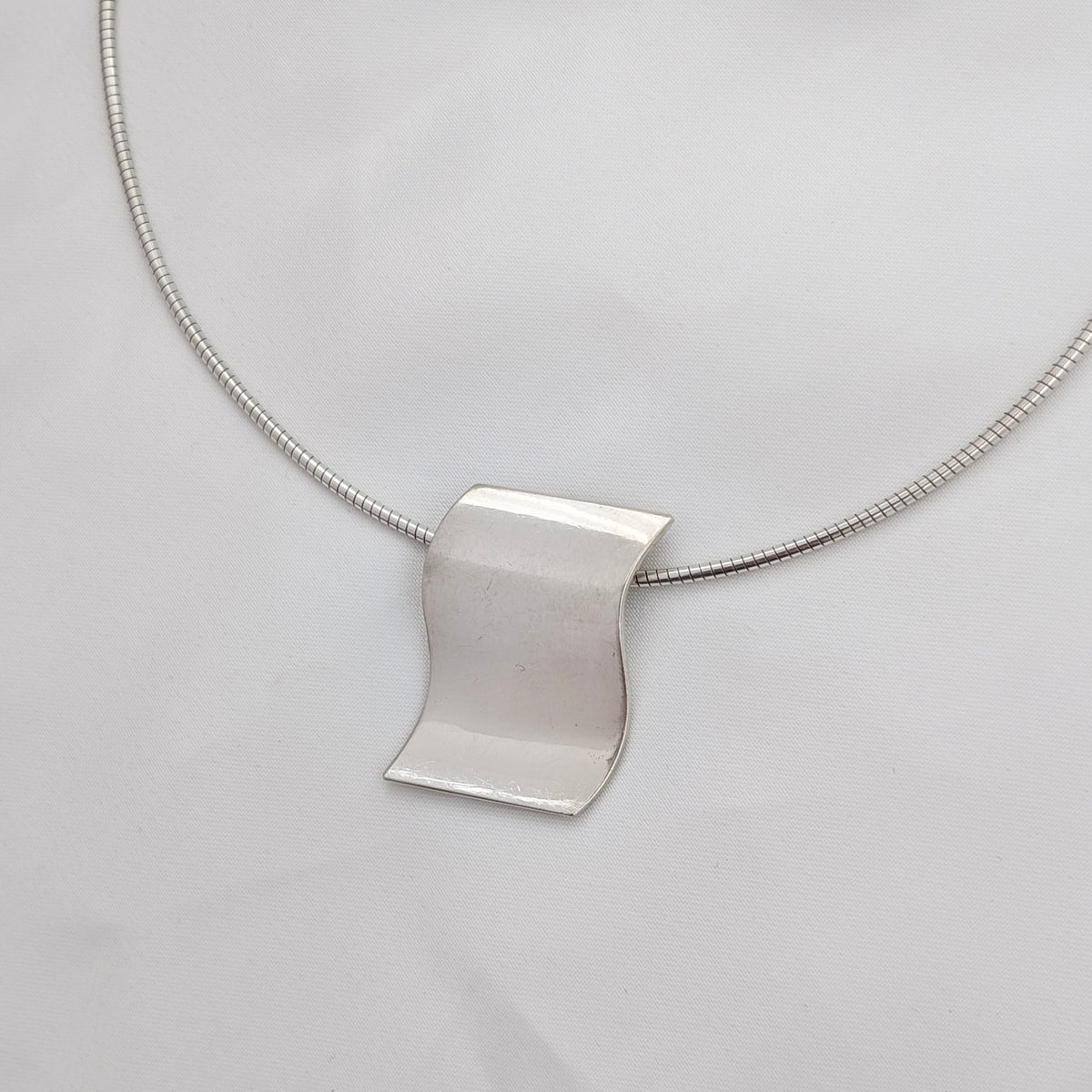 A Modernist Sterling Silver Pendant on Omega Chain