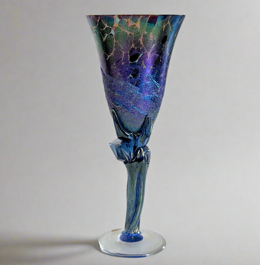 Blue and purple glass vase on a white surface with a white background